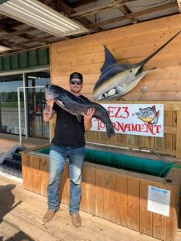 Taner Rudolph, a Marine Corps veteran from Hubert, holds up his state record 26-pound channel catfish caught in the Neuse River near Kinston in July.