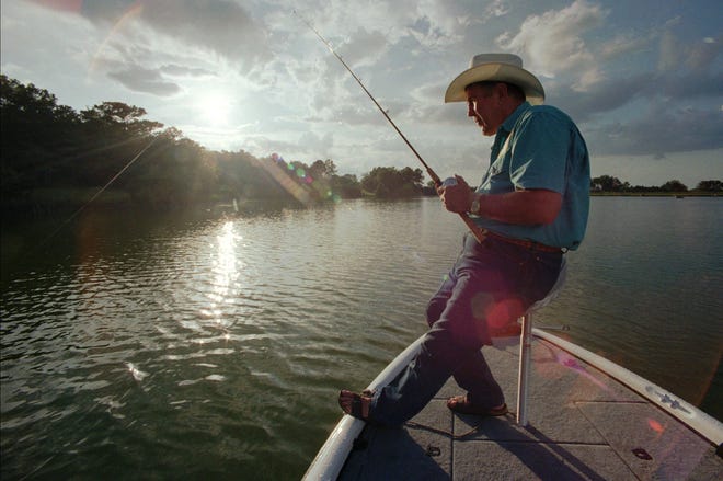 BASS founder Ray Scott works a line on the lake next to his Alabama home in 1998.