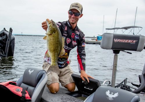 Matt Becker holds up a catch during a professional bass fishing tournament held along Lake Champlain