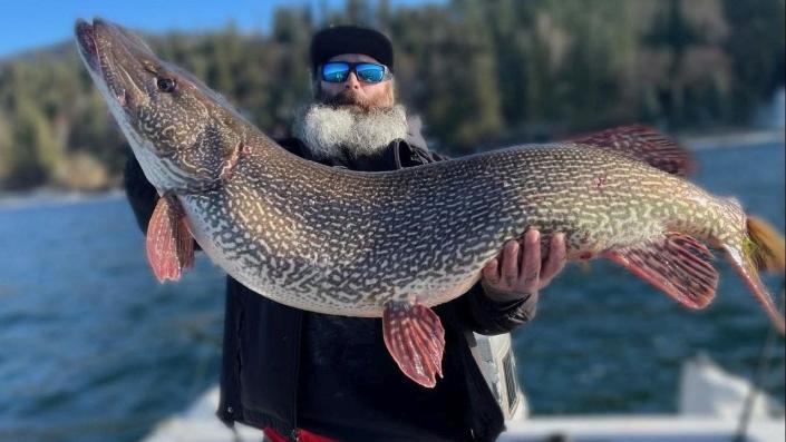 Idaho man Thomas Francis holds record-breaking northern pike while on boat