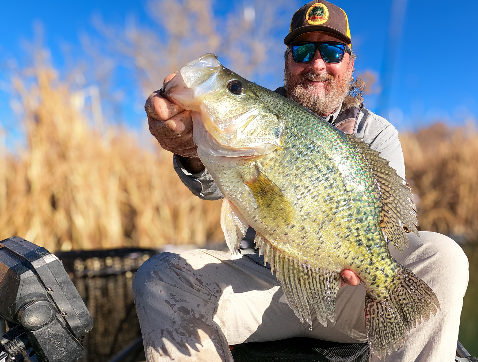 A kayak angler holds up a state-record crappie caught in Colorado.